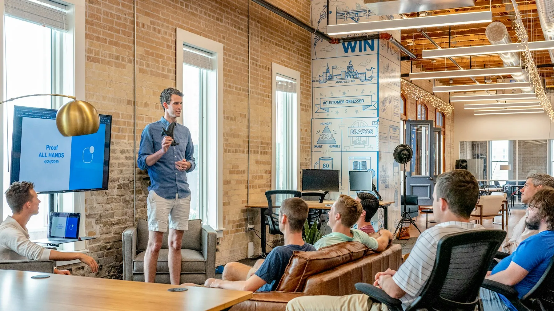 Team gathered for a casual all-hands in a bright office